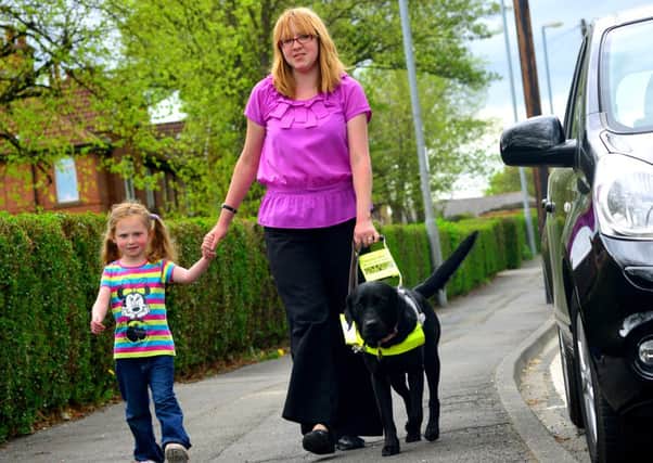 RAISING AWARENESS Sam Heaton with her guide dog Tango and daughter Daisy.
