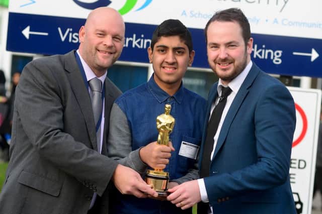 PRACTICE Mr Mitchell, Musharaf and Mr Burton with the Oscar won by The Kings Speech last year.(D531G346)
