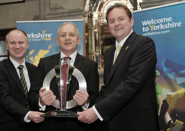Chief executive of Leeds City Council Tom Riordan, Leader of Leeds City Council Coun Keith Wakefield and Chief Executive of Welcome to Yorkshire Gary Verity with the Grand Départ trophy at Civic Hall.