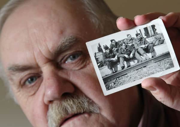 After buying a used book from the coop in Mirfield, Peter Batley found an old photograph of soldiers from 1943 being used as a bookmark - it still has all the names of the soldiers on the back in pencils - he is on the lookout for their relatives and wants to solve the mystery.