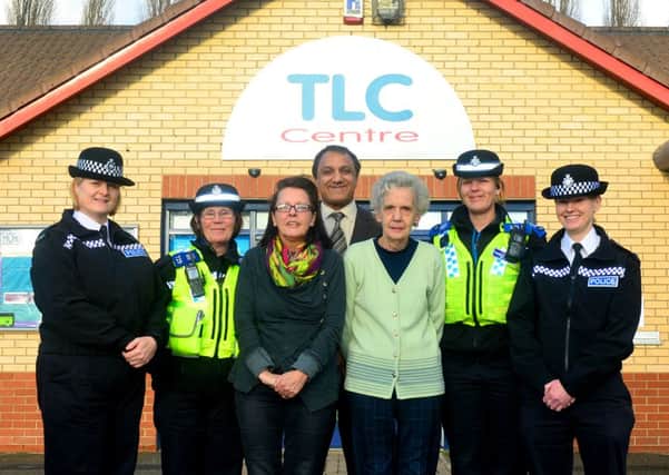 REPORTING CENTRE Police officers and police community support officers join Coun Masood Ahmed and community centre staff in Thornhill Lees.
