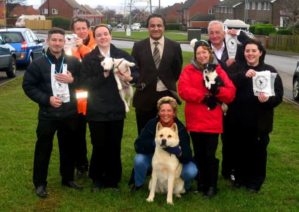 CLEAN UP Coun Masood Ahmed with Kirklees Neighbourhood Housing staff and dog walkers.