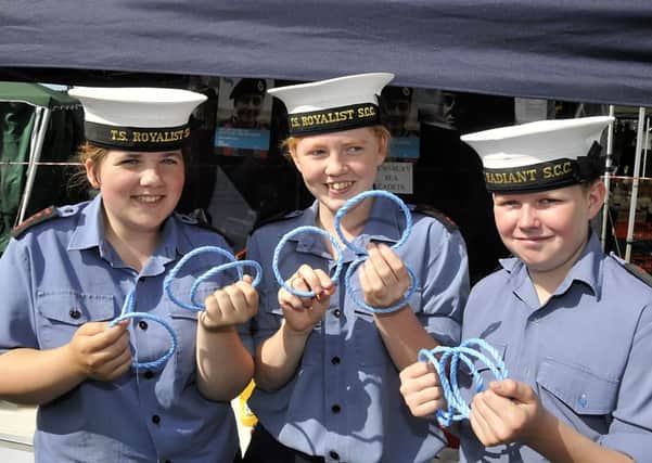 ROLL UP Dewsbury Sea Cadets Megan Wilson, Tara Luff and Mark Firth help run a hoopla stall at last years show.
