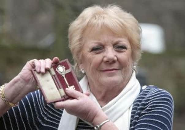 Maureen Prest with the key used for the club's official opening, courtesy of Huddersfield Examiner.