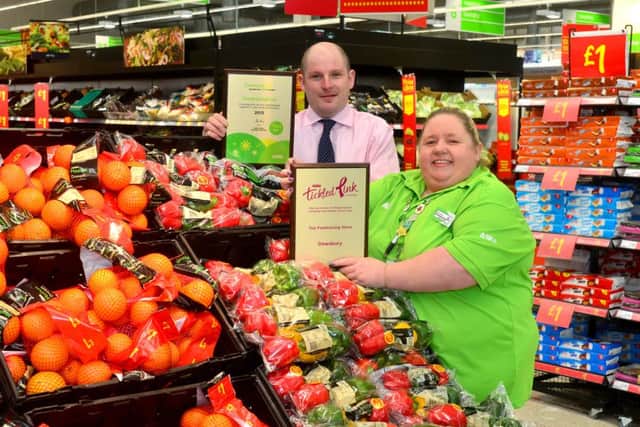 The team at Asda in Dewsbury has scooped two national awards - one for raising £100 000 in seven years for the Tickled Pink campaign and another for its work in the community. Community life champion Sharon Kingswood and Martyn Stainton (new store manager) with the awards. (D511B405)