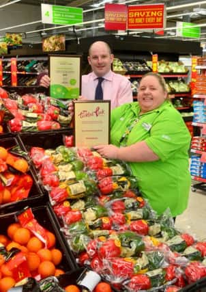 The team at Asda in Dewsbury has scooped two national awards - one for raising £100 000 in seven years for the Tickled Pink campaign and another for its work in the community. Community life champion Sharon Kingswood and Martyn Stainton (new store manager) with the awards. (D511C405)