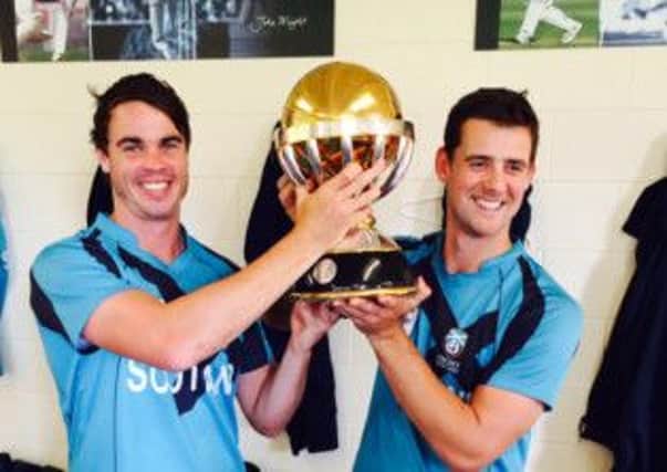 Iain Wardlaw, left, holds the ICC World Cup qualifying trophy with Scotland teammate Rob Taylor.