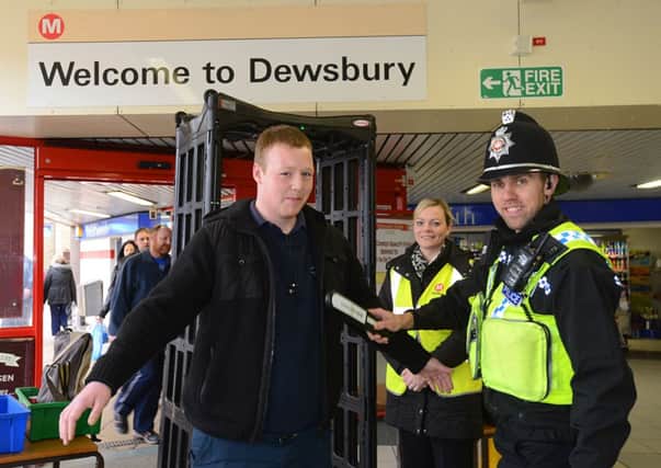 WILLING VOLUNTEER PC Richard Shires searching volunteer Richard Teun at Dewsbury bus station as part of the exercise. Also pictured is Jodie Booth, bus station manager.