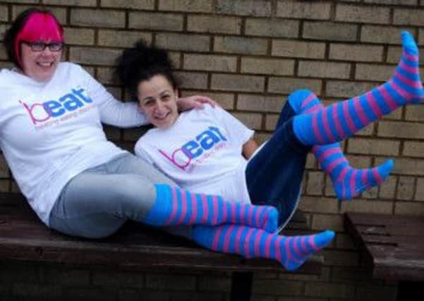 FEDS members Cherie Hinchcliffe and Ouadia Lewis kick-start Sock It to Eating Disorders.