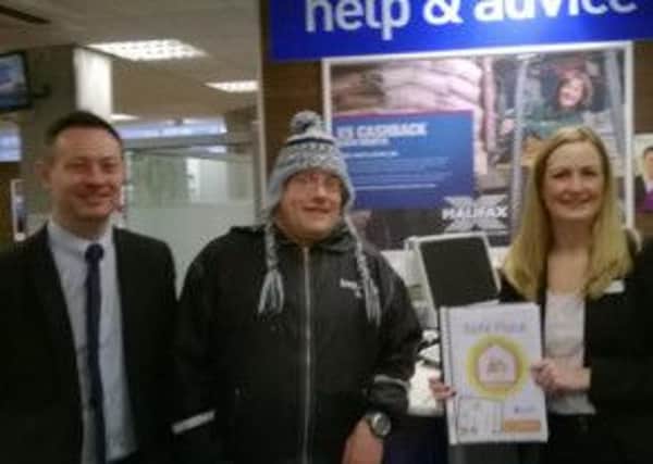 SAFE PLACES Damian Greenwood and Vicki Malone from the Halifax Bank with Andrew, one of the service users.