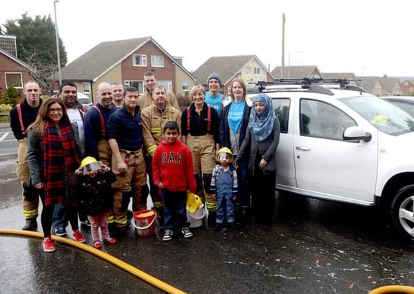 CAR WASH Firefighters and Barclays staff ran a charity car wash. (d306a410)