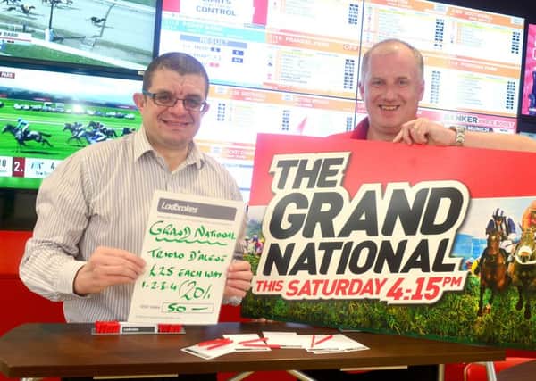 Andrew Hunt places the Reporter Series charity bet with Ladbrokes Manager Shaun Jones. (D512C413)