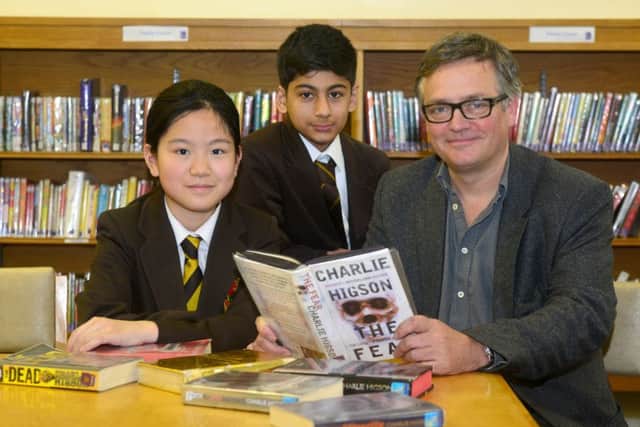 FAMOUS FACE Author Charlie Higson meets Heckmondwiek Grammar School pupils Jenny Zhang and Huzaifah Cheema. (D534J413)