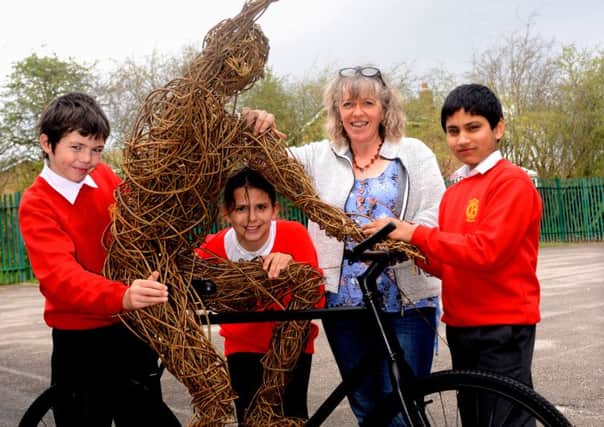 Pupils are making a willow sculpture of a cyclist to celebrate the tour de france coming to yorkshire Old Bank School, pictured are pupils Ben Carpenter, Husnain  Abdal and Anazstazia Kanya and Carole Beavis. (d605a414)
