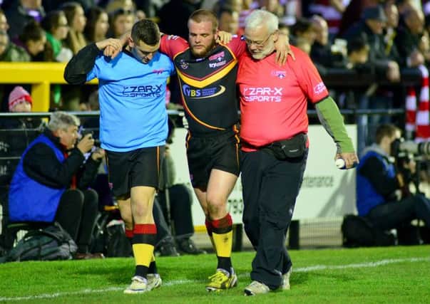 Aaron Brown is helped from the field during last Fridays game against Wigan Warriors.