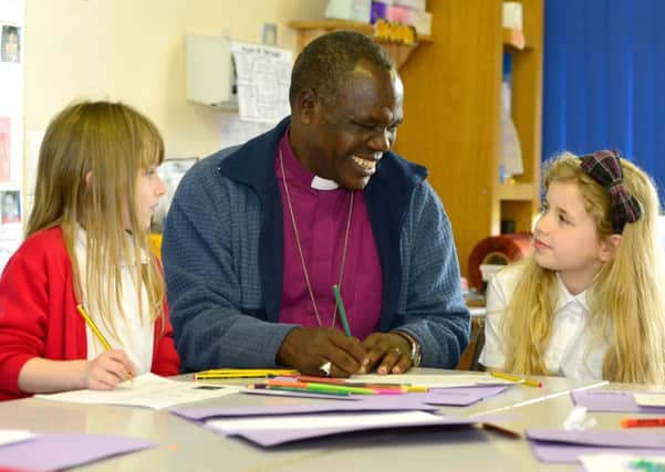 Bishop Hilkiah of Mara from Tanzania visited Bywell School. He was speaking to pupils in classrooms. Talking with Chloe Dickinson and Isobel Robinson. (D533D414)