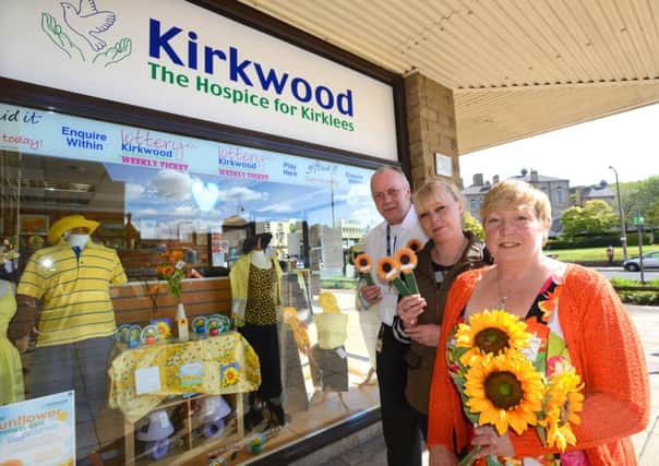 SUNFLOWER MEMORIES Kirkwood Hospices Dewsbury shop is supporting the campaign. Pictured are Amanda Burda, Doris Hatch and Graham Nightingale.