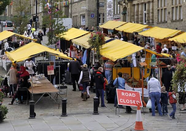 The busy scene of stall holders in the Market Place at Batley Festival.