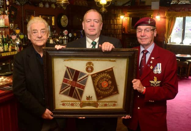 HEROES TRIBUTE Landlord Tim Wood with Legion president Barry Fretwell and Legion member Mick Webber and the colours. (D523B419)
