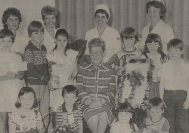FAREWELL SURPRISE Pupils at Birkenshaw First School with retiring cook Kathleen Brooke in May 1984.