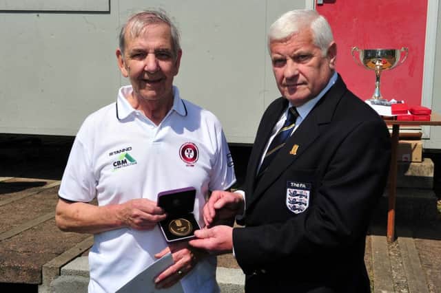 BIG DAY Derek Senior is handed his 50 award by Barry Chaplin, Chairman of the West Riding FA.