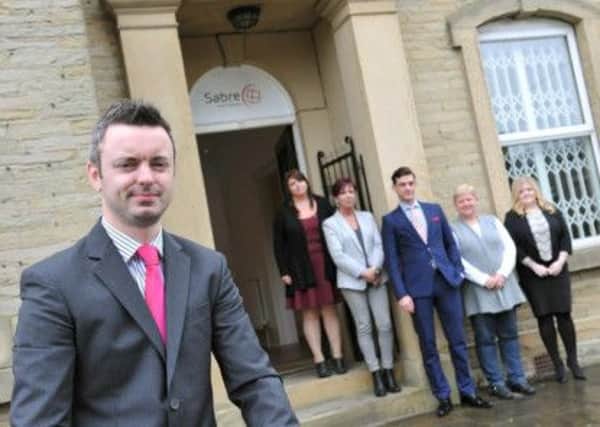NEW HOME Lee Meadowcroft and staff outside their new building in Cleckheaton.