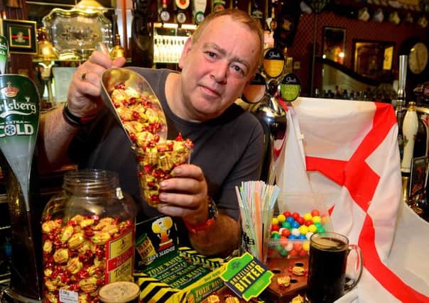 BRAZIL NUTS Landlord Tim Wood has taken council advice to use sweets to silence rowdy football fans to heart. (d533e423)