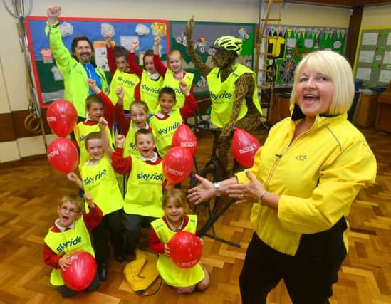 MELLOW YELLOW Learning mentor Janet Ramm and Aubrey Cooper from Kirklees Skyride join Old Bank School children ahead of Wear it Yellow Day. (d522a424)