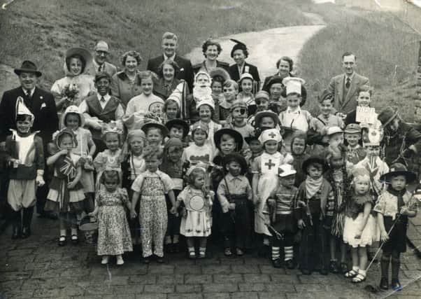 COMMUNITY CELEBRATION This picture of a street party to celebrate the Queens Coronation in 1953 was taken in Hartley Grove at the top entrance to Batley Carr Park. The children lived in Hartley Street and Tolson Street. Among the adults are Harry V Smith, far left, his wife, Ethel, Harold Purdy, local shopkeeper Mary Haigh, and Gladys Swithenbank.