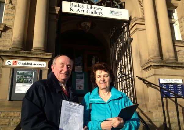Malcolm Haigh and Susan White outside Batley Library with protest petition forms last year.
