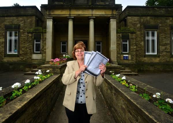 Eileen Newsome with Cleckheaton Library deeds which she say confirms it must remain an open library. (D541C430)