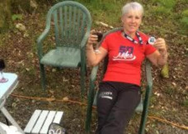 Sally Salter takes a well deserved rest after completing the Lakeland 50 Ultra Marathon.