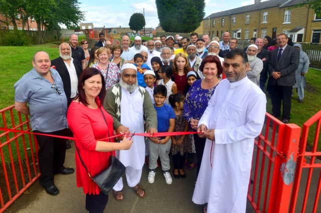Beaumont Street Play Area in Mount Pleasant has become the George Speight Memorial Park at the request of ward councillors. Bernadette Speight cuts the ribbon with Gulam Maniyar and Masum Karolia. (D553G432)