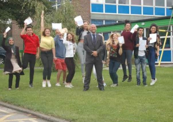 Pupils at Thornhill Community Academy jump for joy with their GCSE results with headteacher Jonny Mitchell.