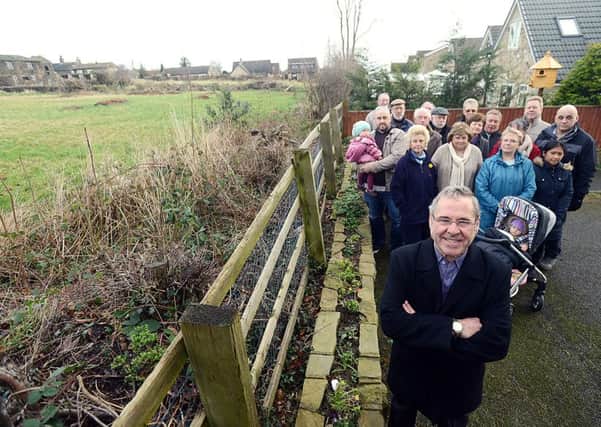 BAD IDEA Peter Morgan and fellow campaigners by land in Lady Heton Drive, which is due to be built on.