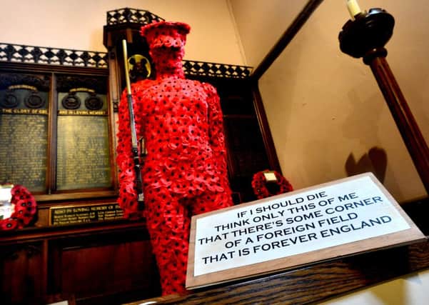 STUNNING DISPLAYS A life-size soldier of handmade poppies at St Saviour's Church. (d554m438)