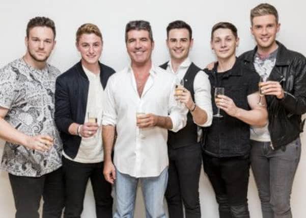 Judge Simon Cowell with last year's winners Collabro.