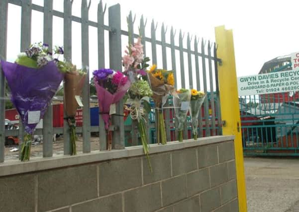 Floral tributes were left outside Gwyn Davies recycling plant. (d611c234)