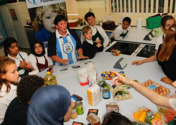 COOKING CLUB Gayna Goalby with pupils during one of the sessions funded by Huddersfield Town Foundation.