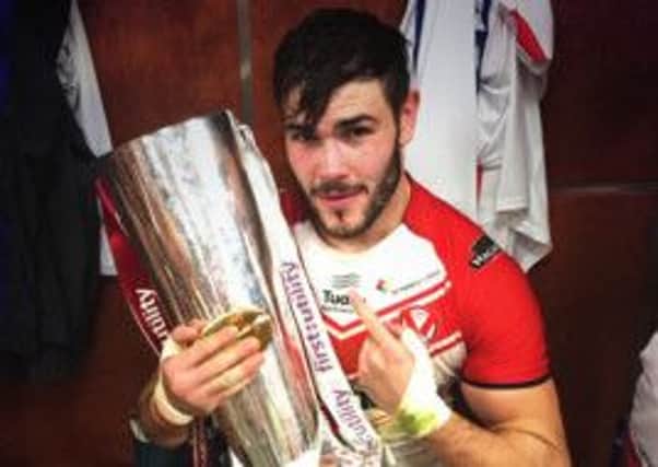 Alex Walmsley gets his hands on the Super League trophy after the Grand Final win over Wigan.