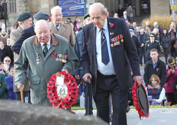 SOLEMN OCCASION Wreaths are laid at a Dewsbury Armistice Day service in 2012.  (d766u246)