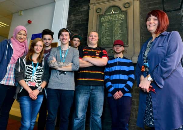 WWI story - tutor Clare Grace with here Art and Design Communication students. They are appealing for info on people named in the Batley School of Art's war memorial so they can create an art project. (D513B443)