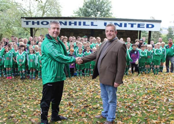 Chris Kennedy with Ian Saville and some of the children from Thornhill United FC.