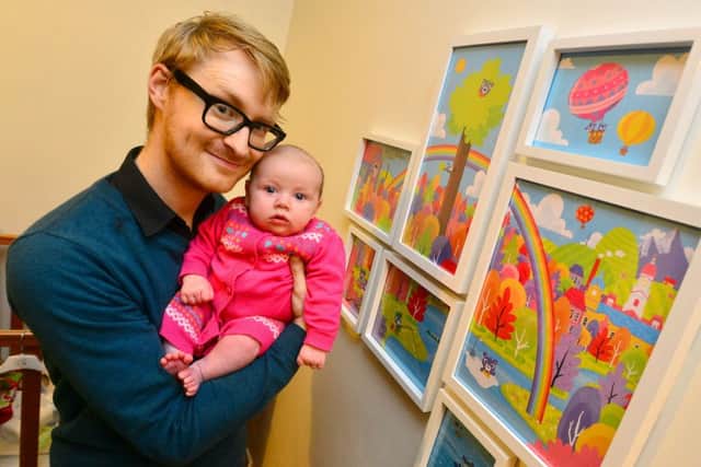 Illustrator Hugh Raine with daughter Bonnie by the mural he has created for her room. (D514B443)