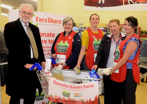 HELPING HAND MP Mike Wood joins in with the collection at Cleckheaton Tesco.  (d605a449)
