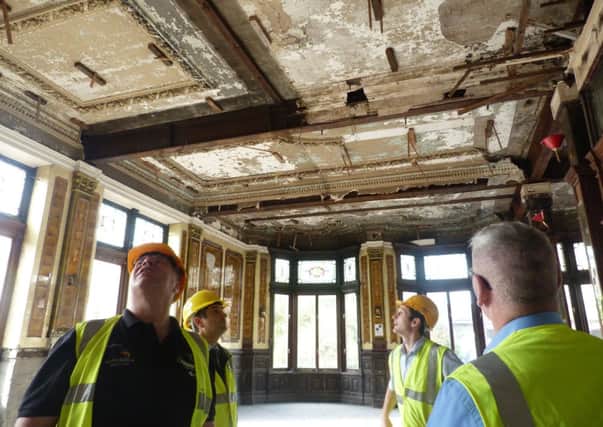 Dave Hall, John Lambe, Luke Oliver and Kevin Byrne examining the part of Pioneer House formerly used as a restaurant.