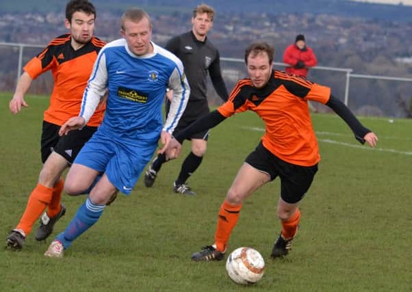 Jamie Beever (Overthorpe) gets away from Thornhill Lees Joel Clegg in the HW Sunday League Premier Division