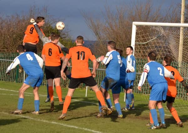 Thornhill Lees' Nathan Kemp leaps high to head towards goal against Overthorpe in the HW Sunday League