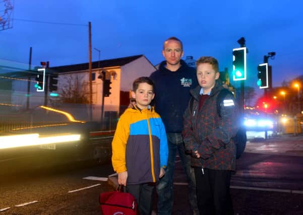 Ian Stuart and his boys (Seb and Jacob) were nearly knocked over when a speeding car drove through the crossing they were on - despite it being on red. (D527C451)