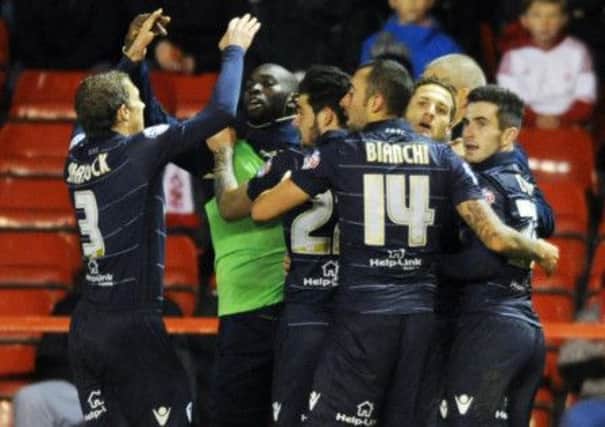 Leeds United players mob Billy Sharp to celebrate his equaliser at Nottingham Forest.